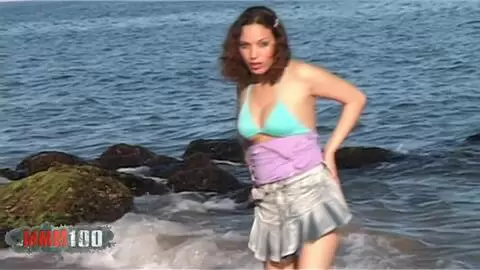 Une belle petite brune fait un strip très chaud en se mouillant dans la mer photo 01